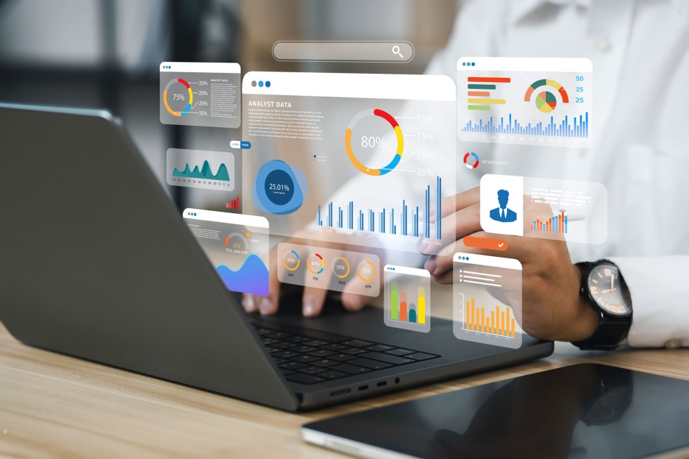 laptop with floating infographics